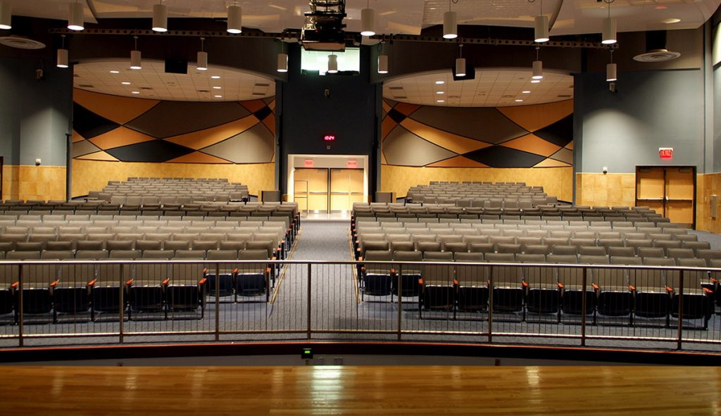 An empty auditorium looking out over the seats from the stage